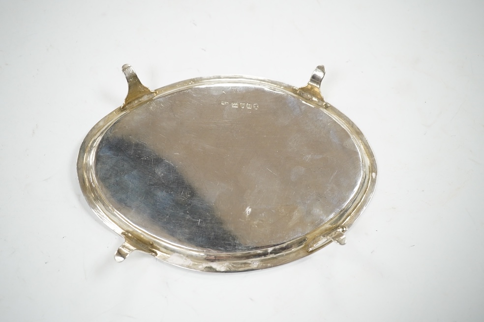 A George III engraved silver oval teapot stand, London, 1796, on four swept feet, 17.3cm, 137 grams. Condition - poor.